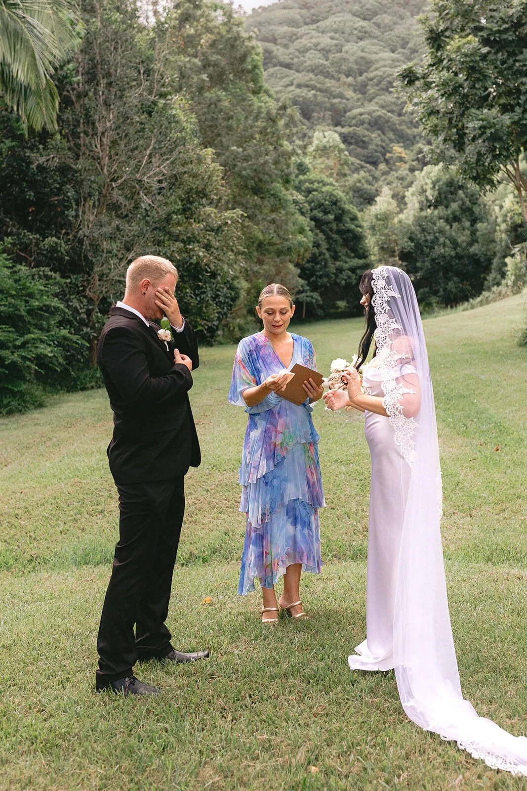 Groom wiping a tear as the celebrant marries the couple, Kobi and Darren's elopement at Butterfly Lane, Byron Bay hinterland