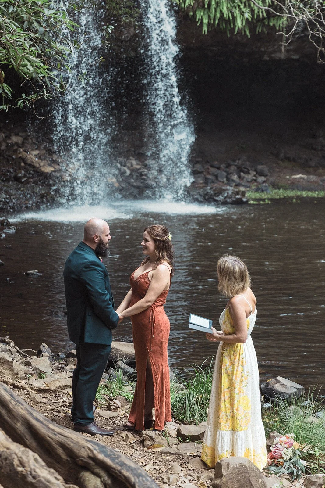 Couple and celebrant in front of the waterfall, Sara and Graeme's elopement at Killen Falls, Northern Rivers