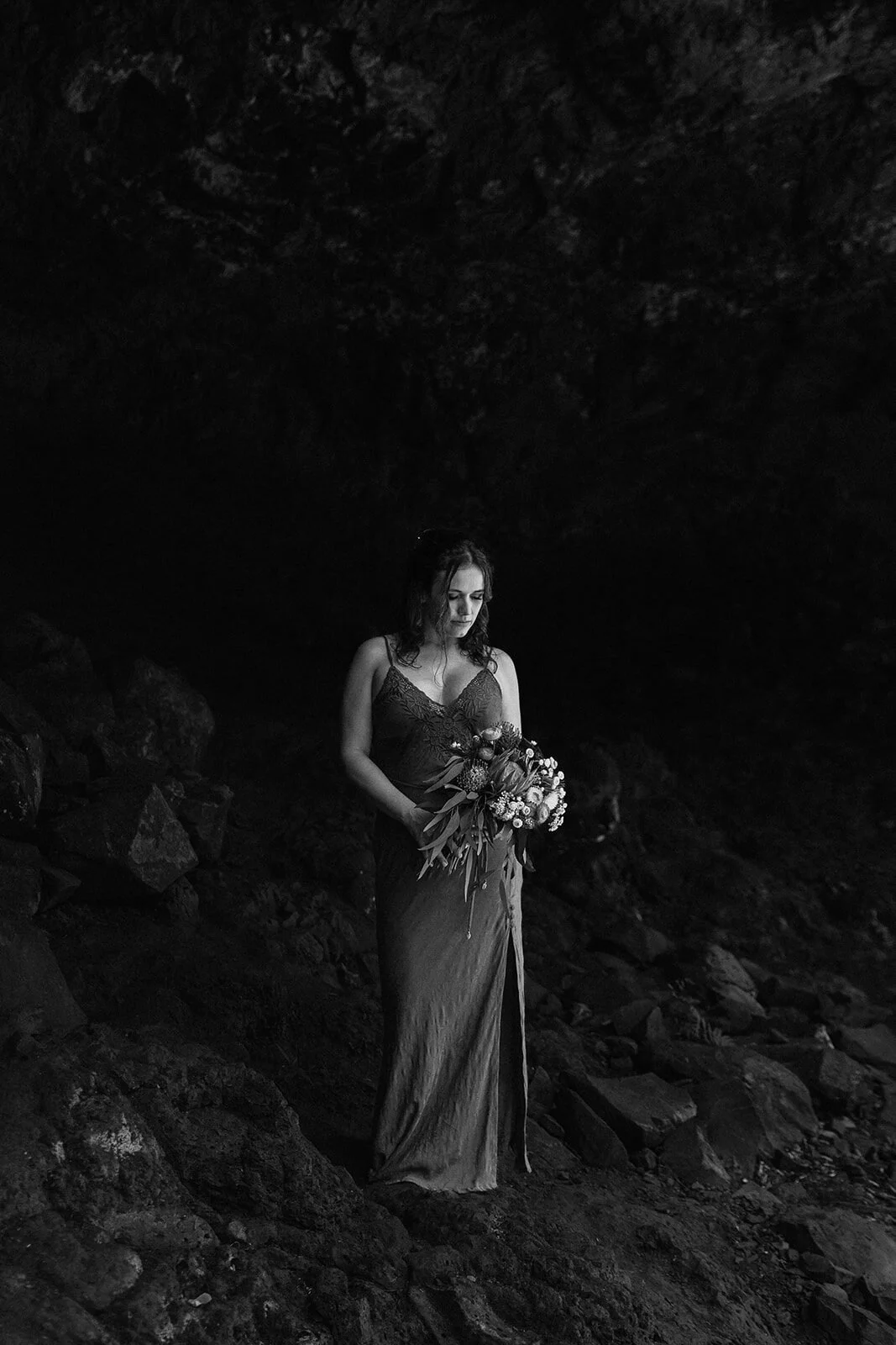 Black and white of the bride in the cave, Sara and Graeme's elopement at Killen Falls, Northern Rivers