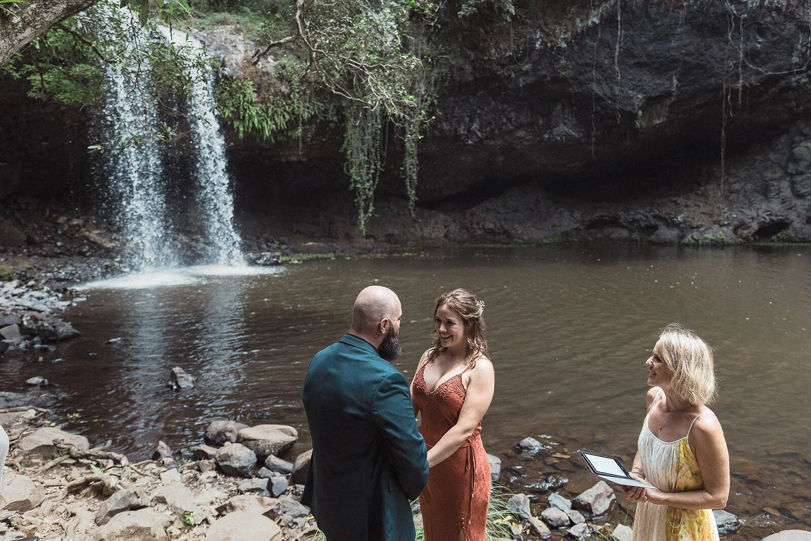 Wide view of the waterfall ceremony beside the pool, Sara and Graeme's elopement at Killen Falls, Northern Rivers