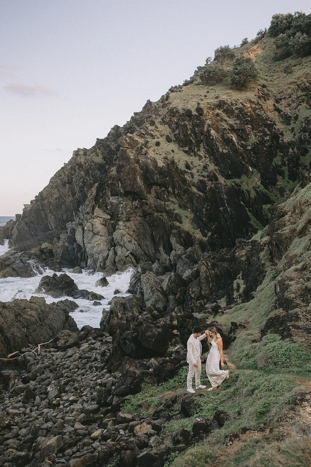 Couple on the rugged rocks of the headland, Abby and James' elopement at Little Wategos Beach, Byron Bay