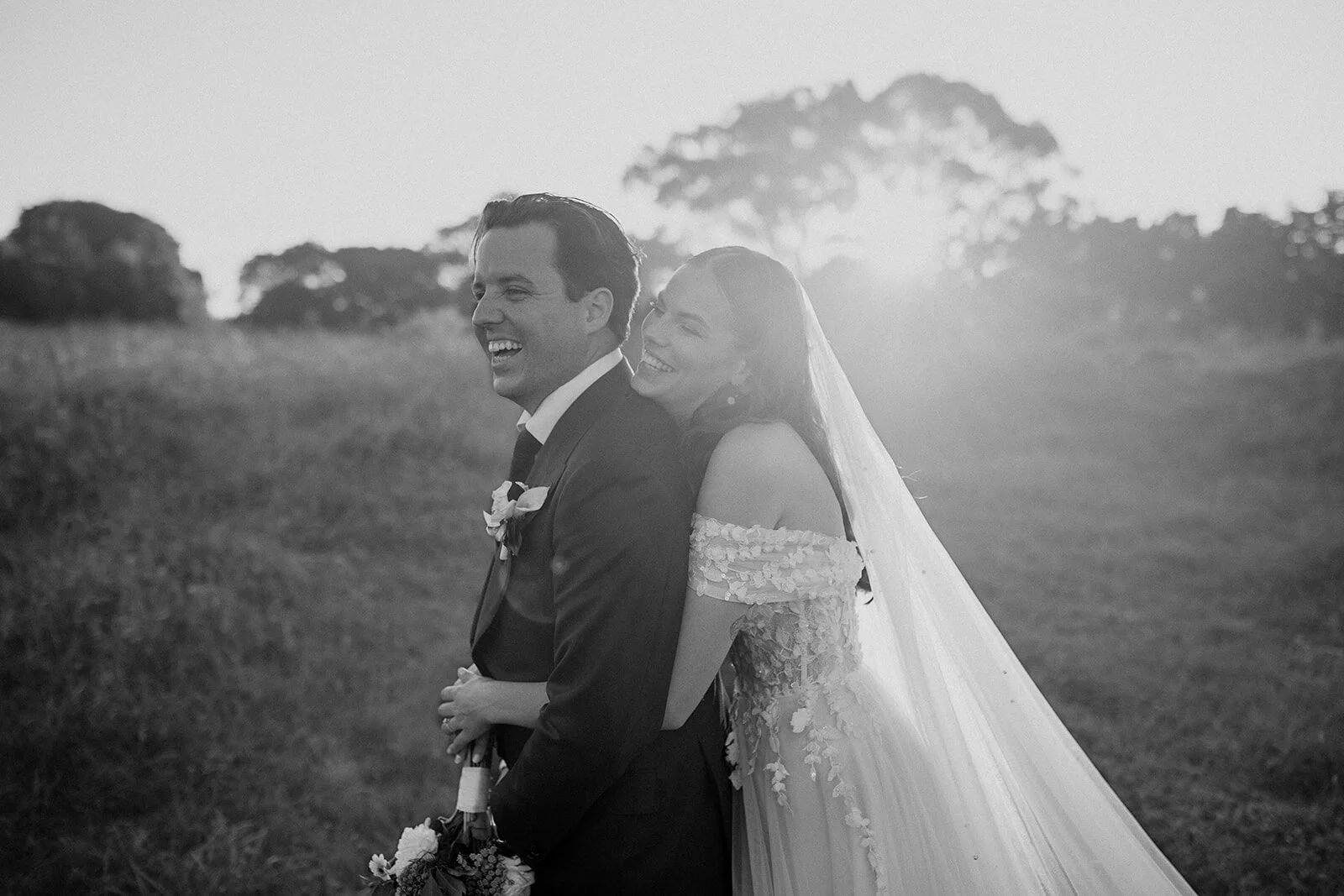 Black and white of the couple laughing, Steph and William's wedding at Earth House, Byron Bay