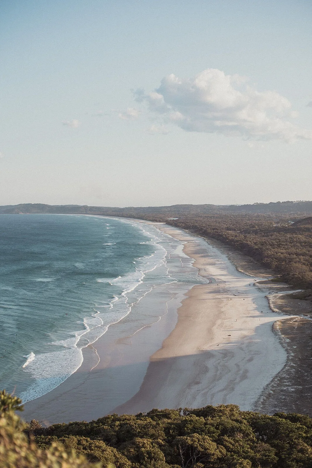View of the long curve of beach and coastline from the Cape Byron lookout, Douglas and Ying's sunset marriage proposal at Cape Byron Lighthouse, Byron Bay