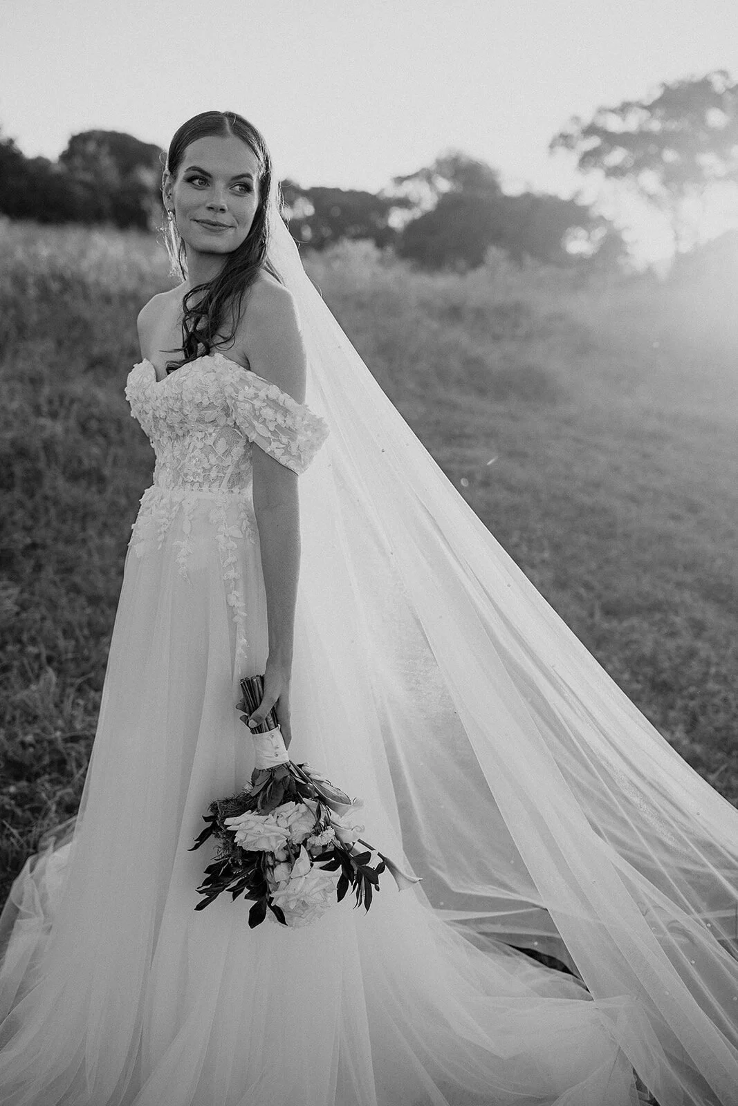 Black and white of the bride looking over her shoulder, Steph and William's wedding at Earth House, Byron Bay