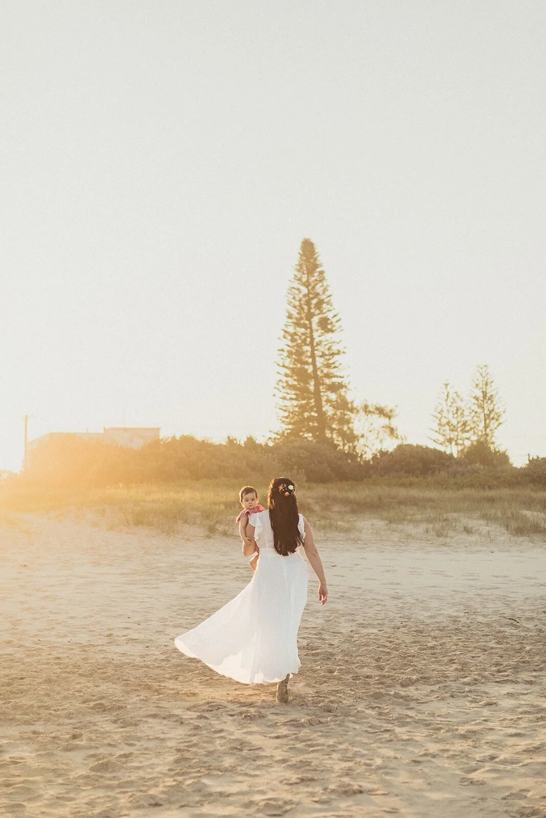 Bride walking away along the beach at sunset, Maritess and Mark's elopement at Lennox Head