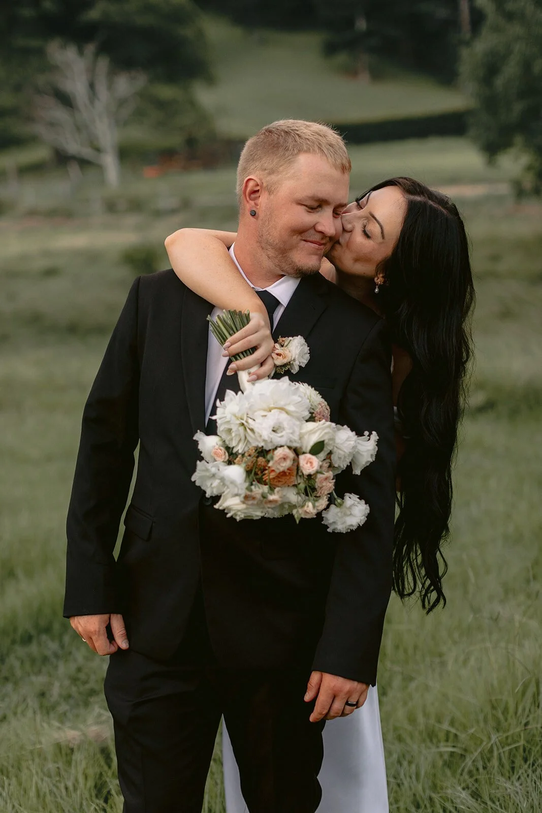 Bride kissing the groom's cheek, Kobi and Darren's elopement at Butterfly Lane, Byron Bay hinterland