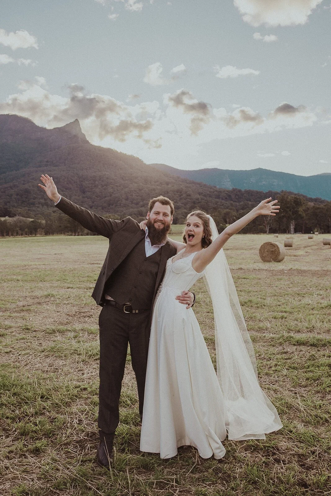 Couple cheering with arms in the air, Sam and Tom's elopement at Highfield Farm, Northern Rivers