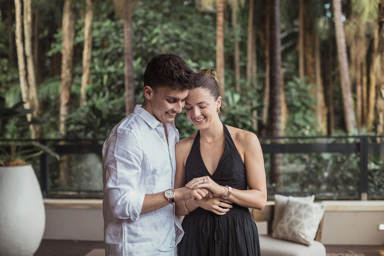 Couple smiling down at the engagement ring, Ben and Chloe's marriage proposal in Byron Bay