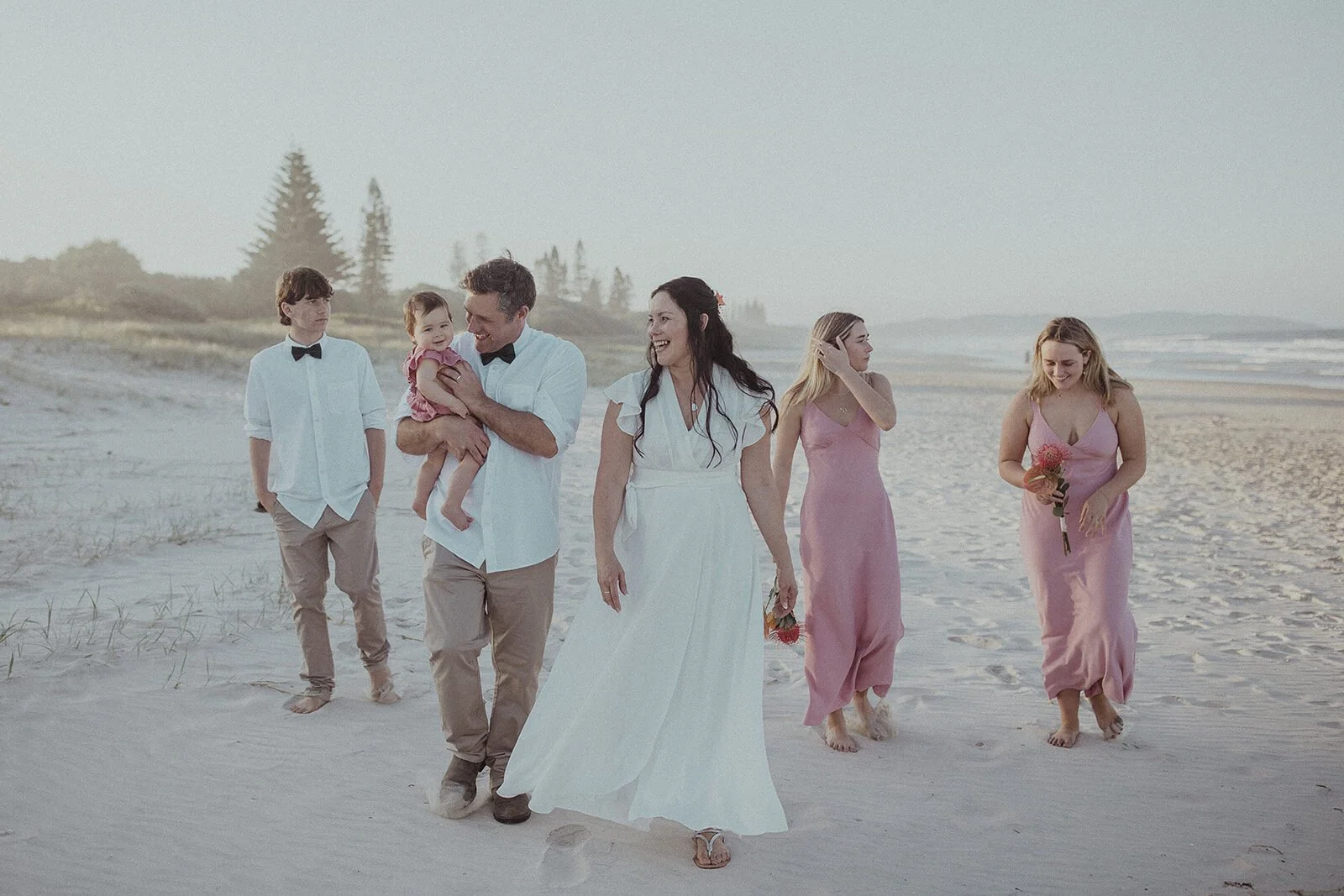 Family walking along the beach together, Maritess and Mark's elopement at Lennox Head