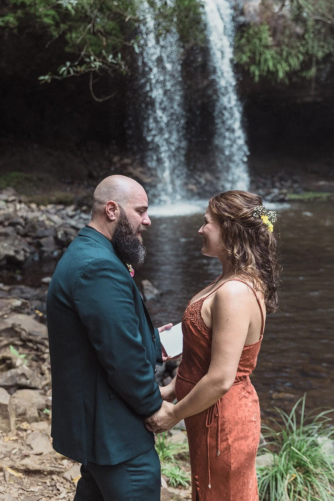 Couple holding hands as the groom reads his vows, Sara and Graeme's elopement at Killen Falls, Northern Rivers