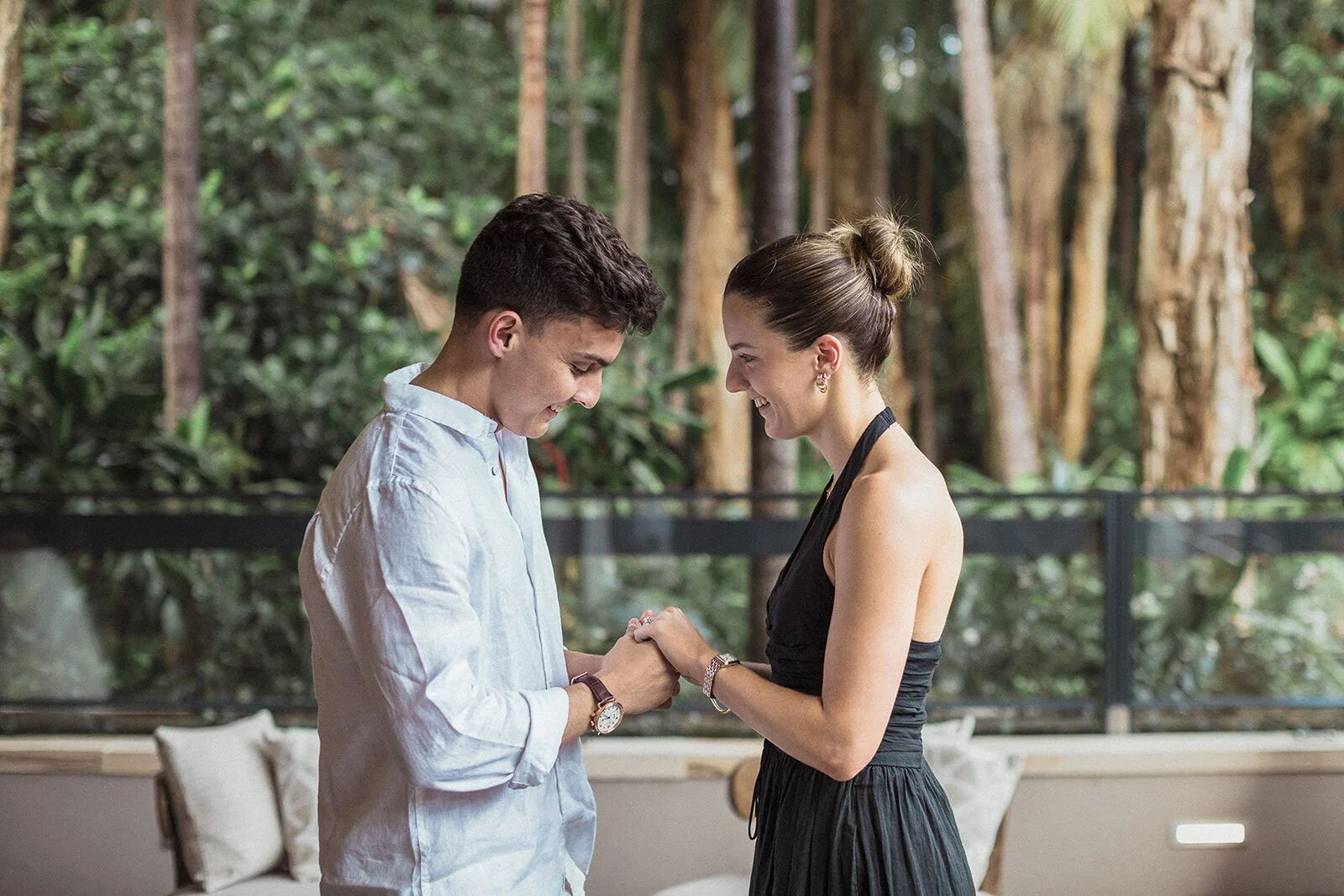 Couple looking at the engagement ring with the rainforest behind, Ben and Chloe's marriage proposal in Byron Bay