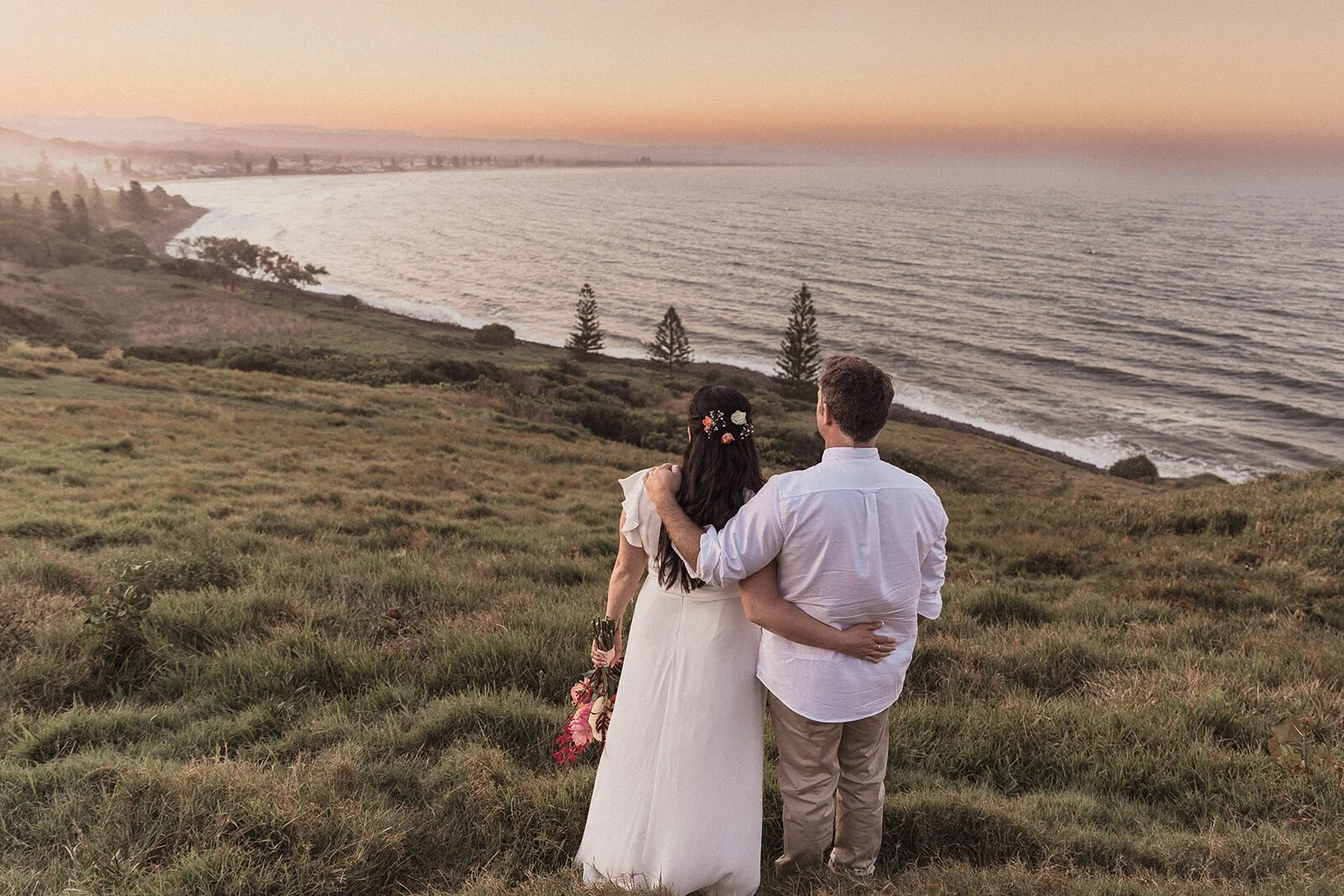 Couple from behind looking out at the coastline, Maritess and Mark's elopement at Lennox Head