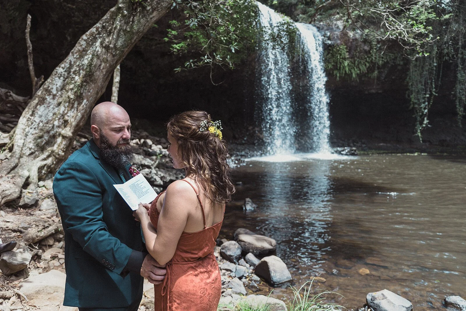 Couple exchanging vows beside the waterfall at Killen Falls, Northern Rivers elopement photographer