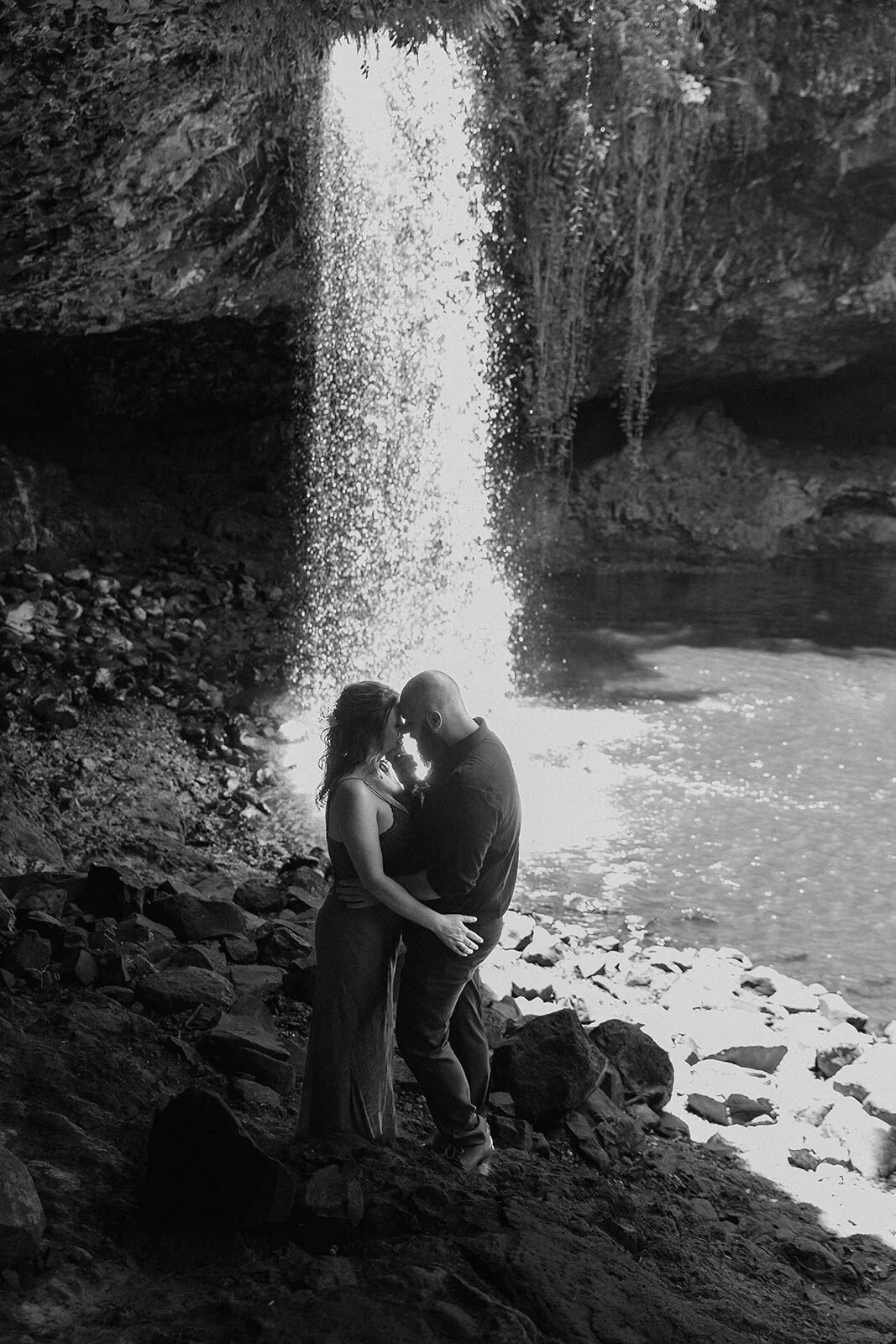 Black and white of the couple embracing at the waterfall, Sara and Graeme's elopement at Killen Falls, Northern Rivers