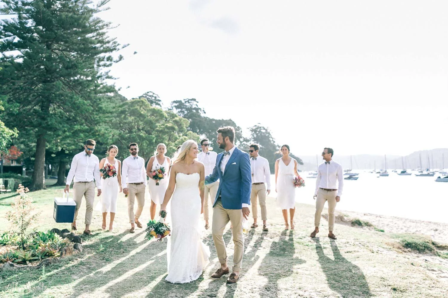 Bride and groom walking with their bridal party at Bilgola Beach on Sydney’s Northern Beaches