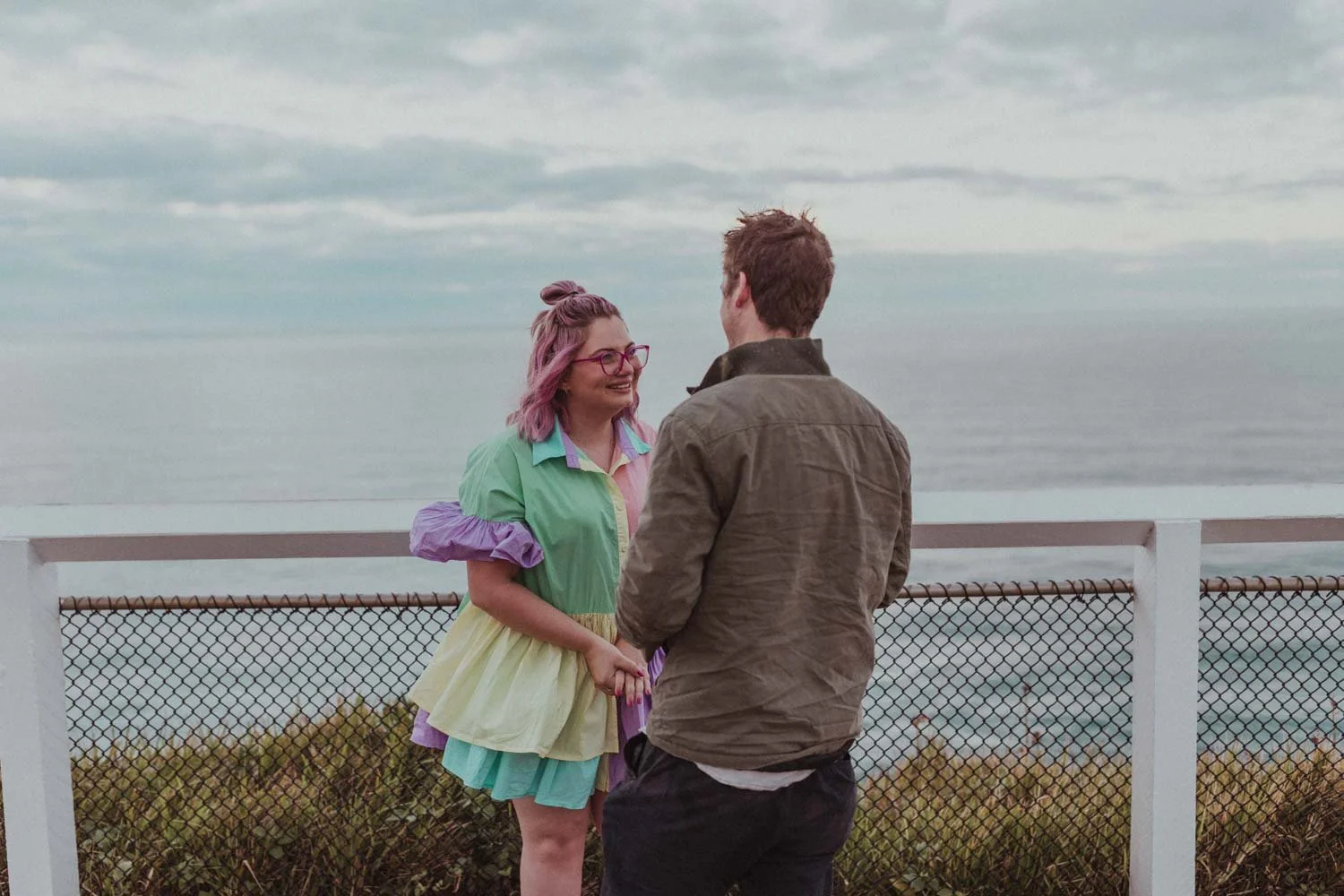 Couple at the Cape Byron Lighthouse lookout during their surprise proposal