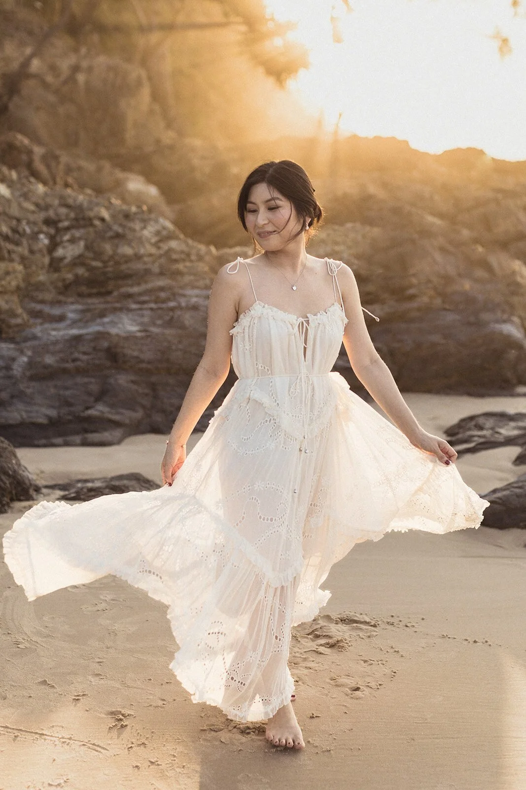 Bride's dress swirling on the beach, Maggie and William's pre-wedding photos in Byron Bay