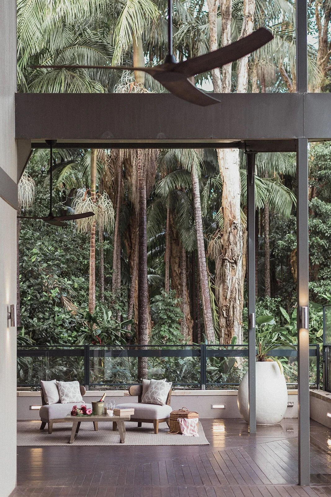 Wide view of a rainforest deck with a lounge set up for a surprise proposal, Ben and Chloe's marriage proposal in Byron Bay