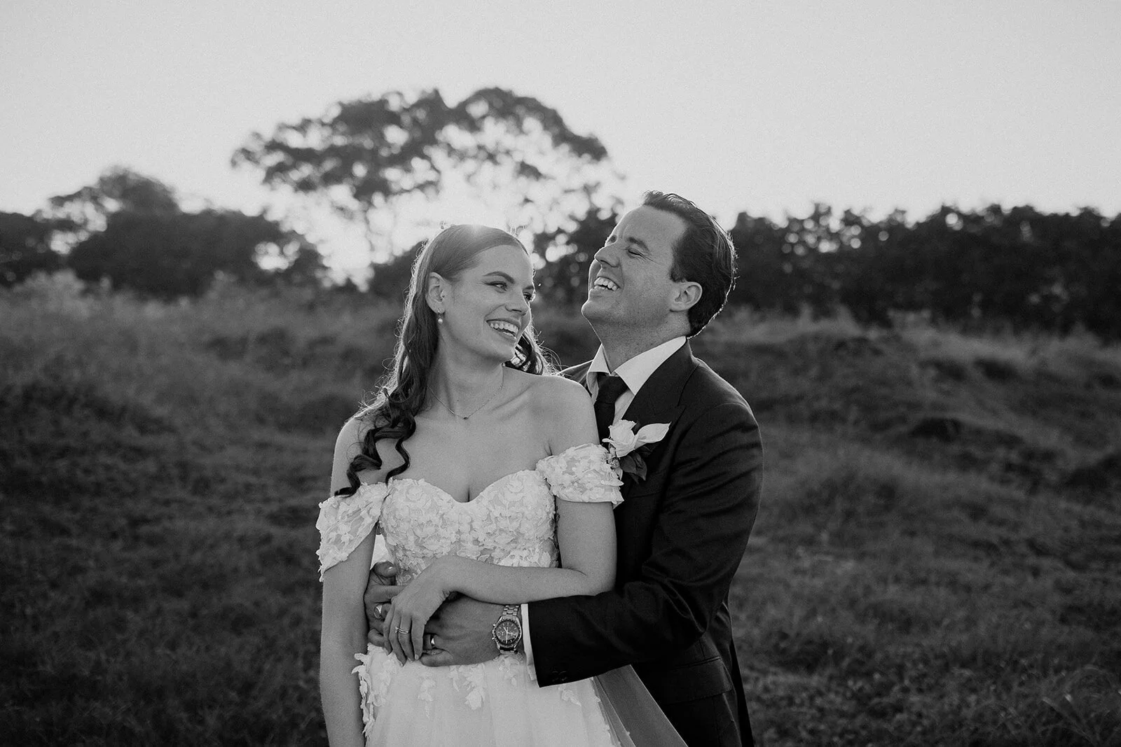 Black and white of the couple laughing together, Steph and William's wedding at Earth House, Byron Bay