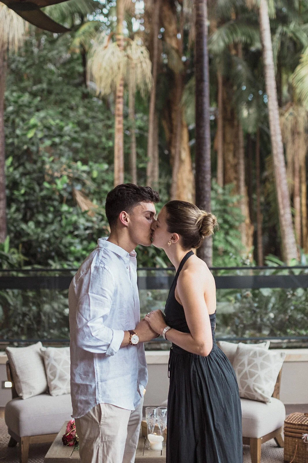 Couple kissing on the deck after the proposal, Ben and Chloe's marriage proposal in Byron Bay