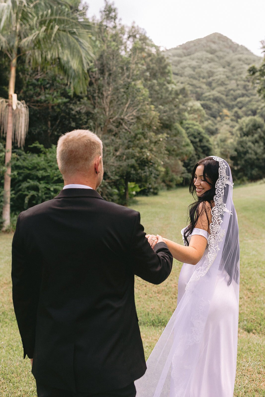 Couple walking together on the lawn, Kobi and Darren's elopement at Butterfly Lane, Byron Bay hinterland