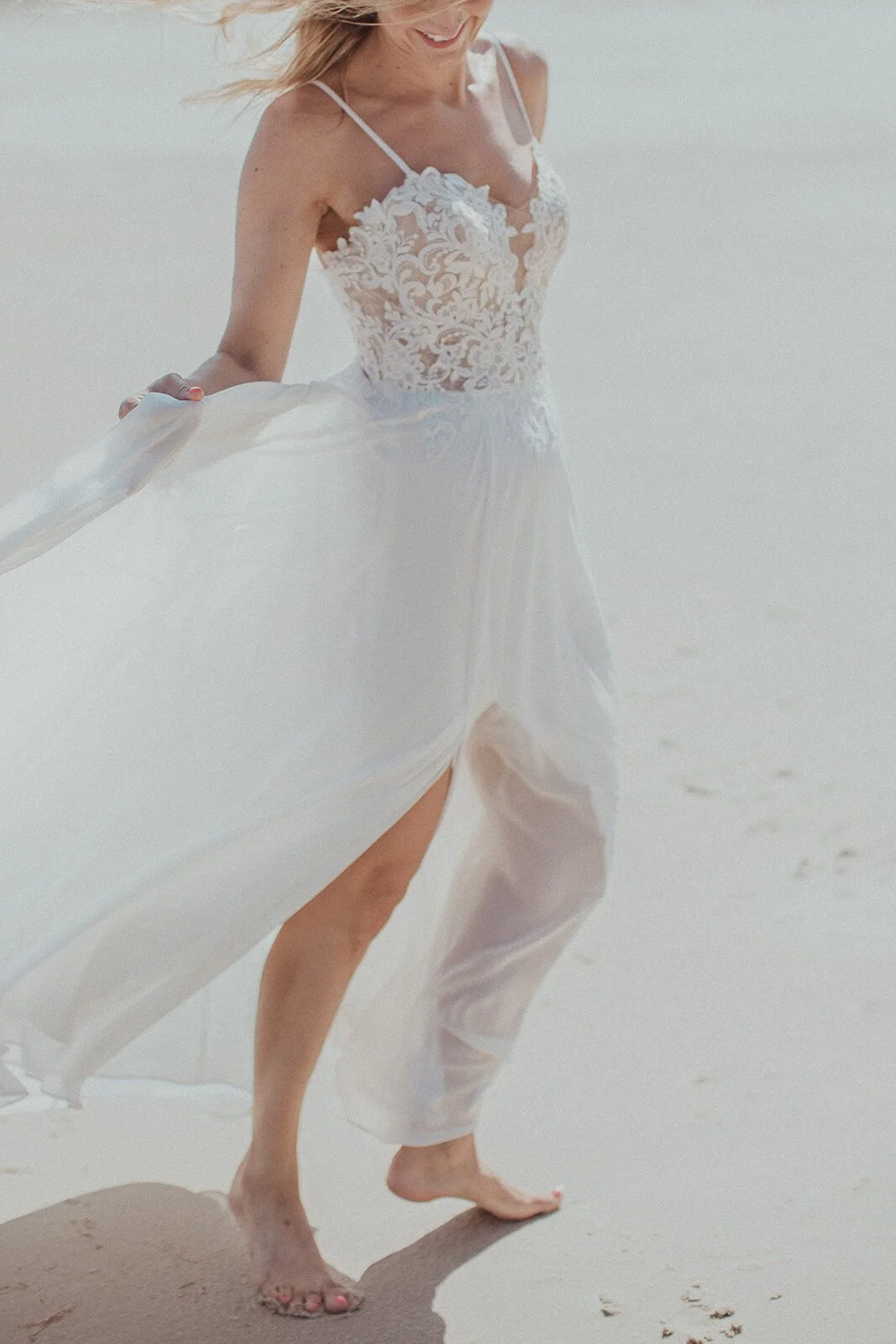 Bride's dress blowing in the wind on the sand, Eliza and Greg's elopement at Broken Head, Byron Bay