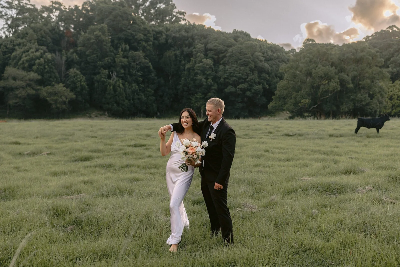 Couple walking through the long grass, Kobi and Darren's elopement at Butterfly Lane, Byron Bay hinterland