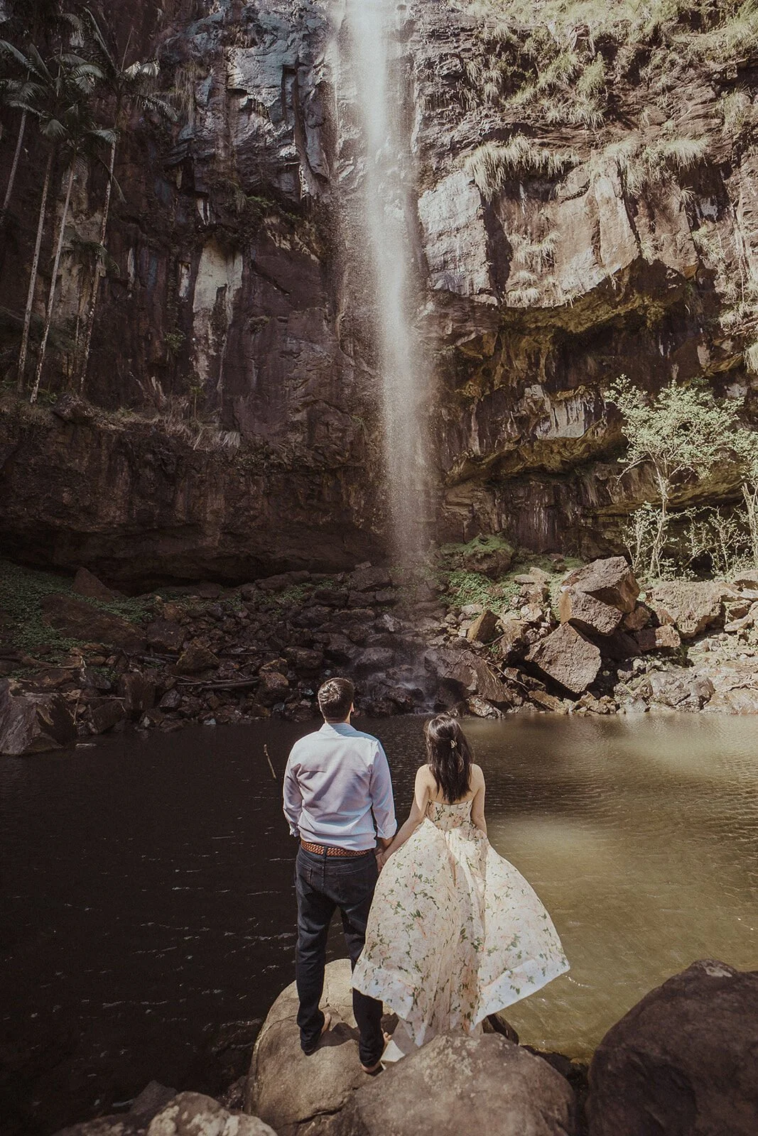 Couple looking at the waterfall from the rocks, Maggie and William's pre-wedding photos in Byron Bay
