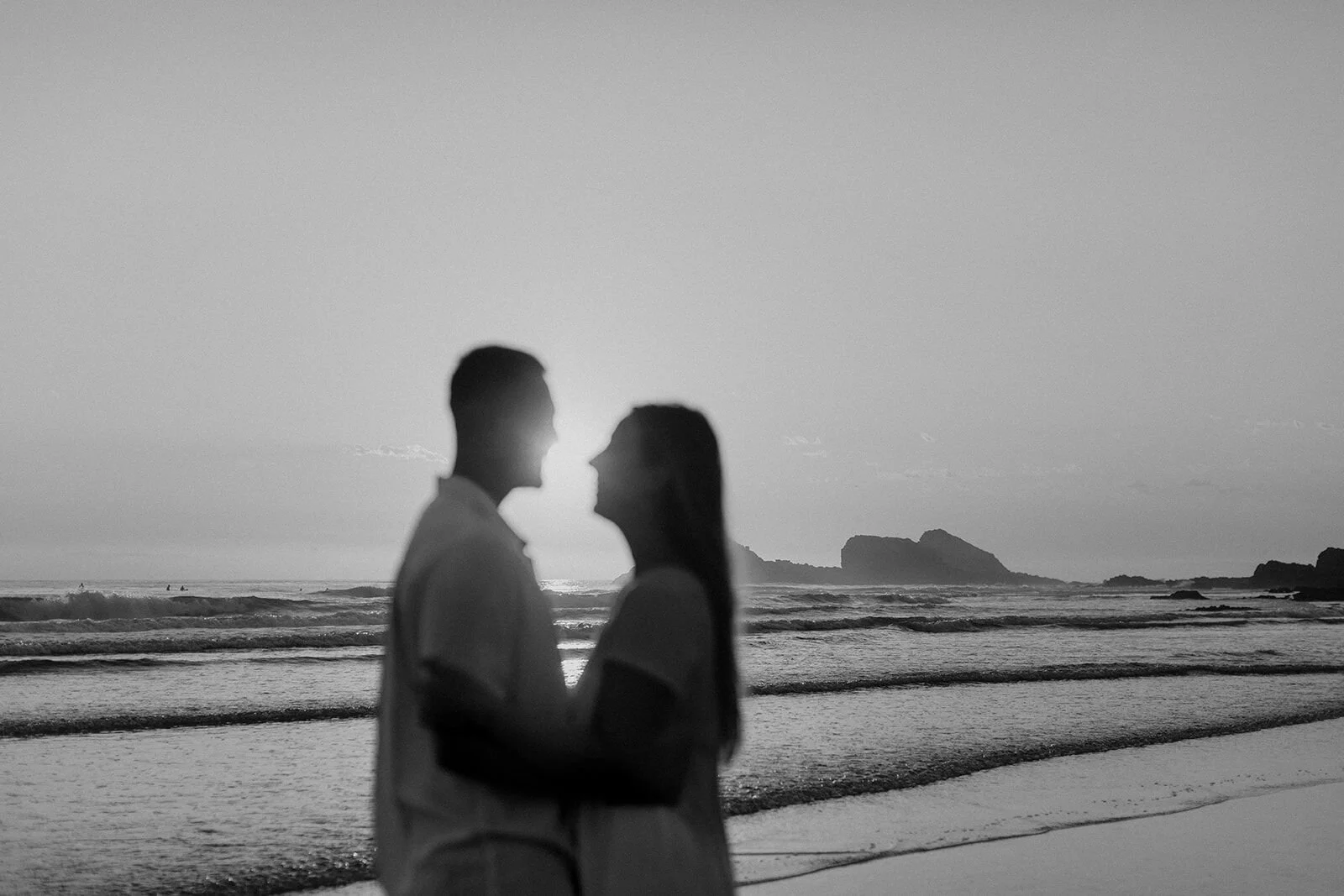 Black and white silhouette of the couple embracing at sunrise, Charlie and Hannah's sunrise marriage proposal at Broken Head Beach, Byron Bay