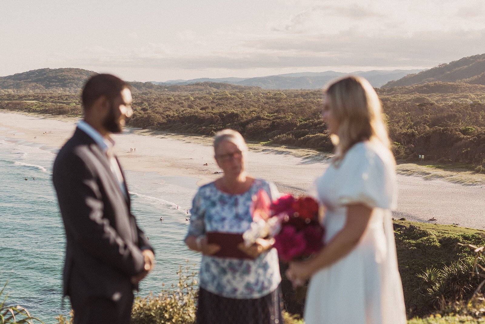 Couple facing the celebrant on the headland above the beach, Brittany and Mark's elopement at Cabarita Beach, Northern Rivers