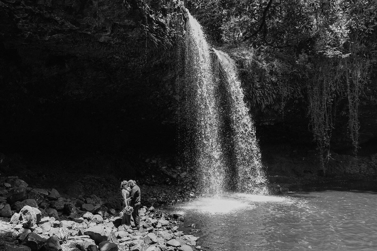 Black and white of the couple kissing at the base of the waterfall, Sara and Graeme's elopement at Killen Falls, Northern Rivers