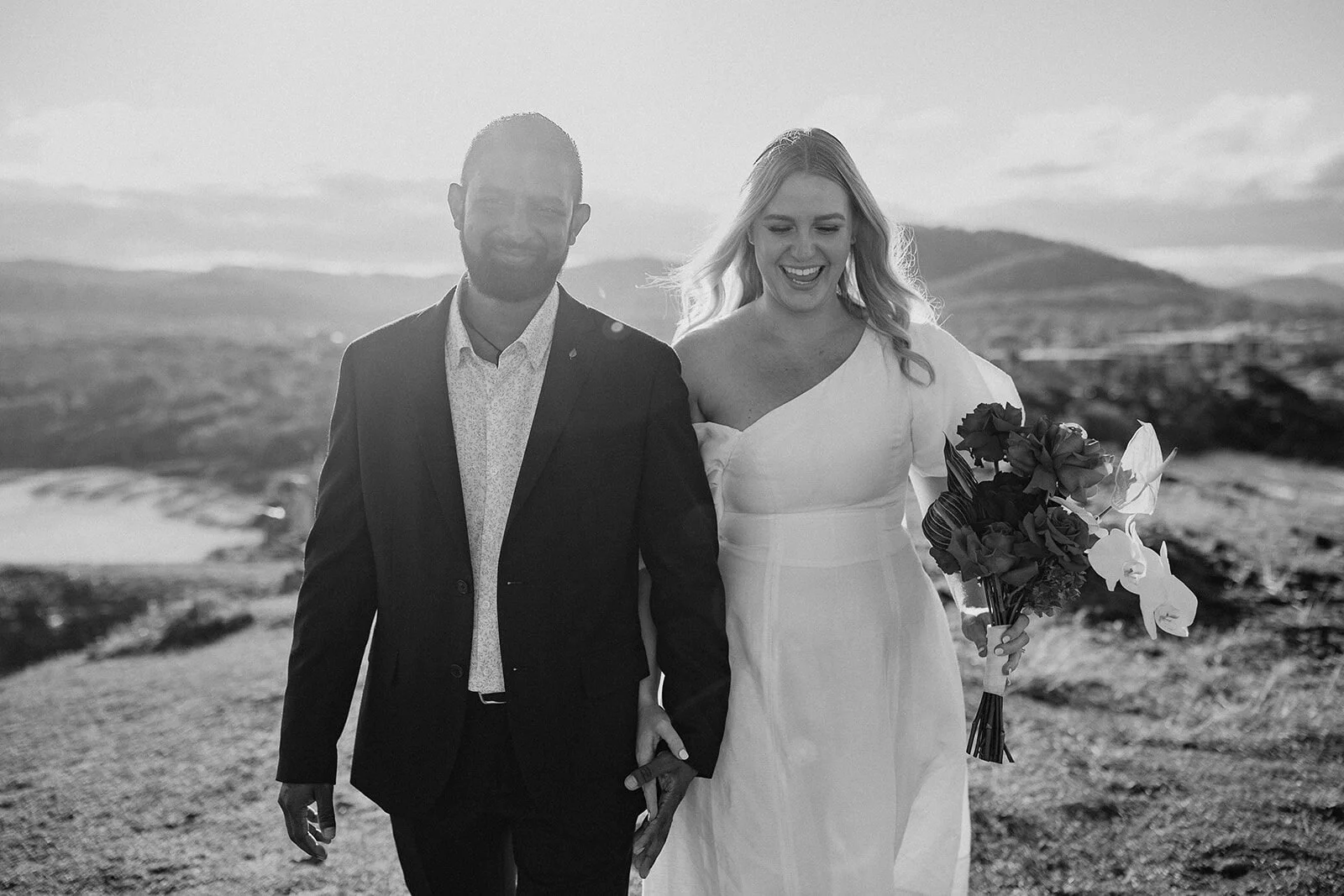 Black and white of the couple walking and laughing on the headland, Brittany and Mark's elopement at Cabarita Beach, Northern Rivers