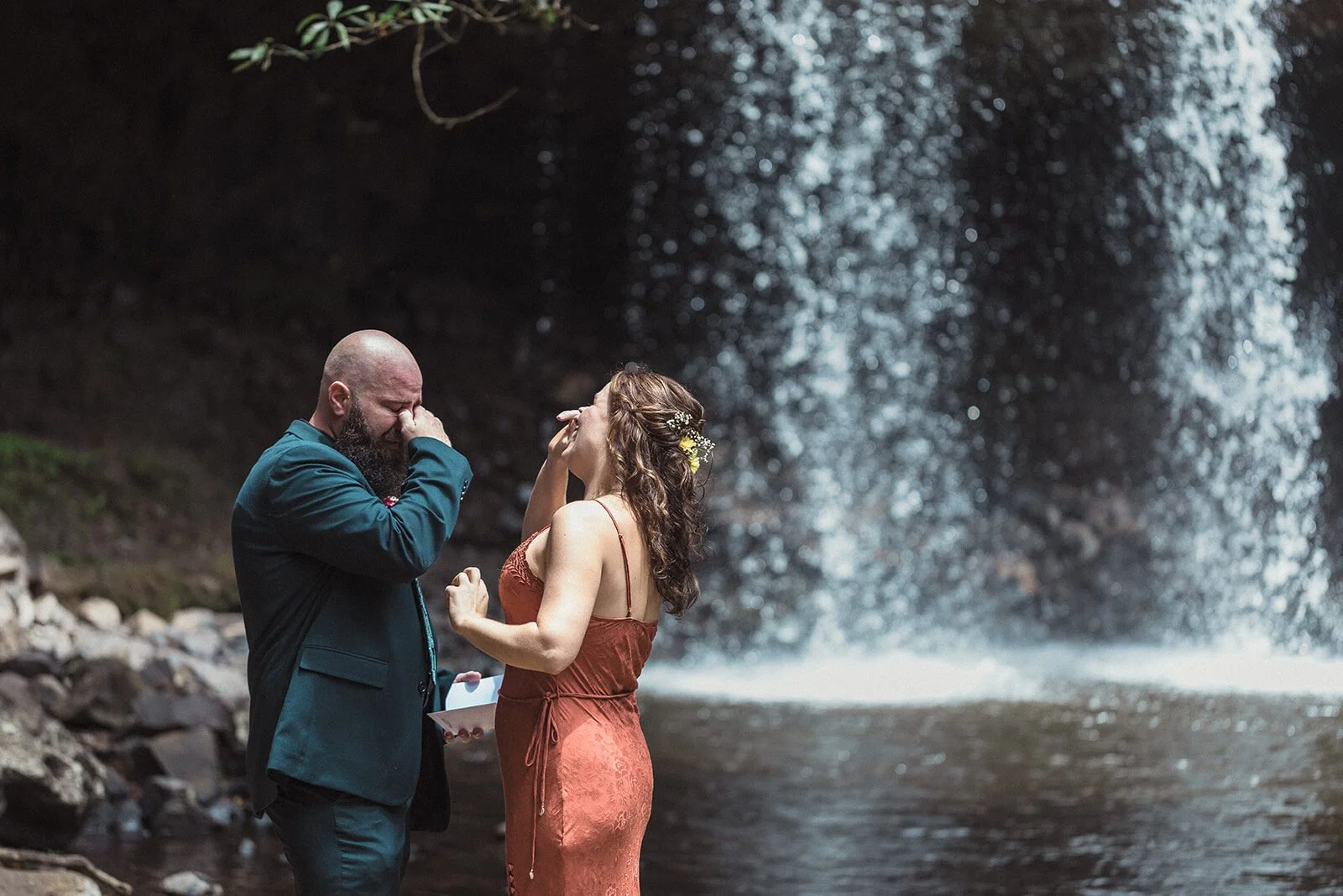 Groom wiping tears as the bride laughs, Sara and Graeme's elopement at Killen Falls, Northern Rivers
