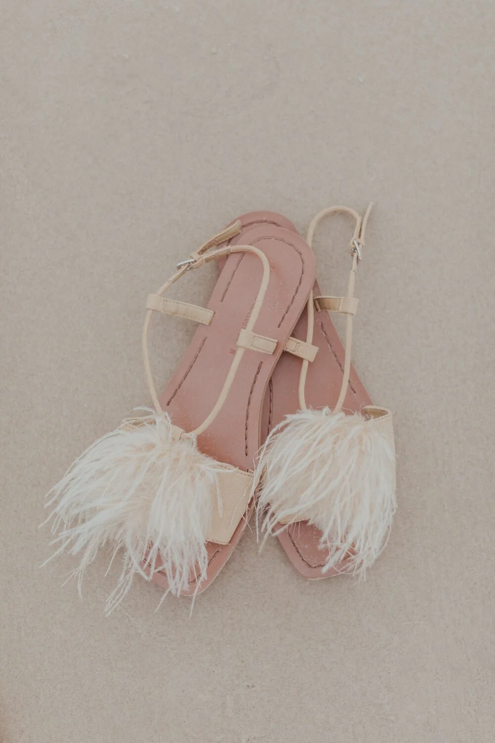 Bride's pink feathered sandals on the sand, Yoanne and Elisa's rainy elopement at Broken Head, Byron Bay