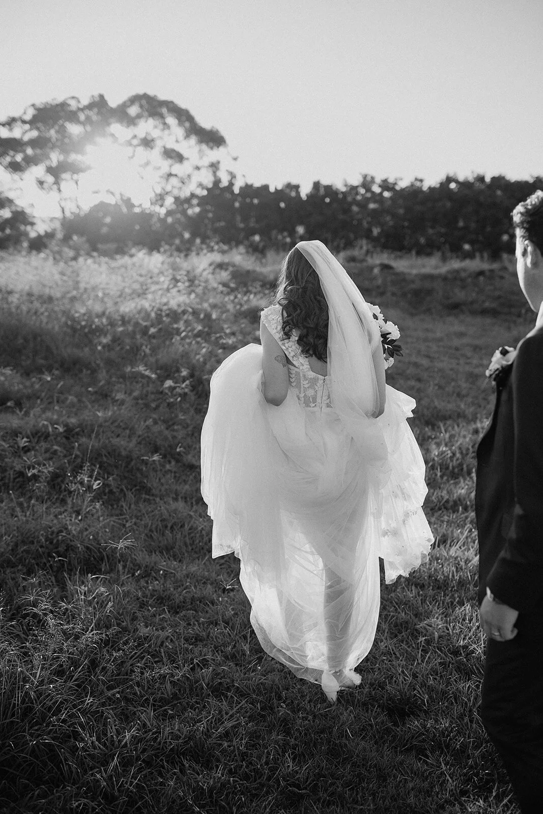 Black and white of the bride walking away from the groom, Steph and William's wedding at Earth House, Byron Bay