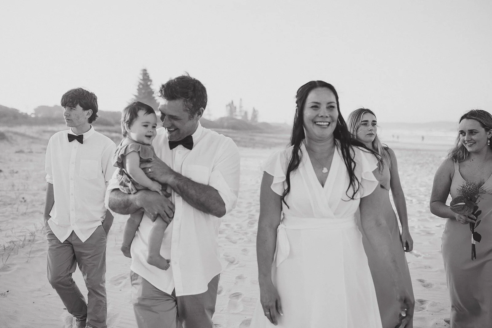Black and white of the family laughing on the beach, Maritess and Mark's elopement at Lennox Head