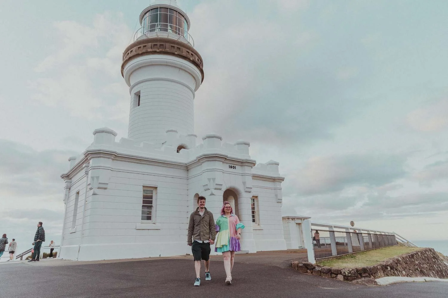 Couple walking towards the Cape Byron Lighthouse after their proposal