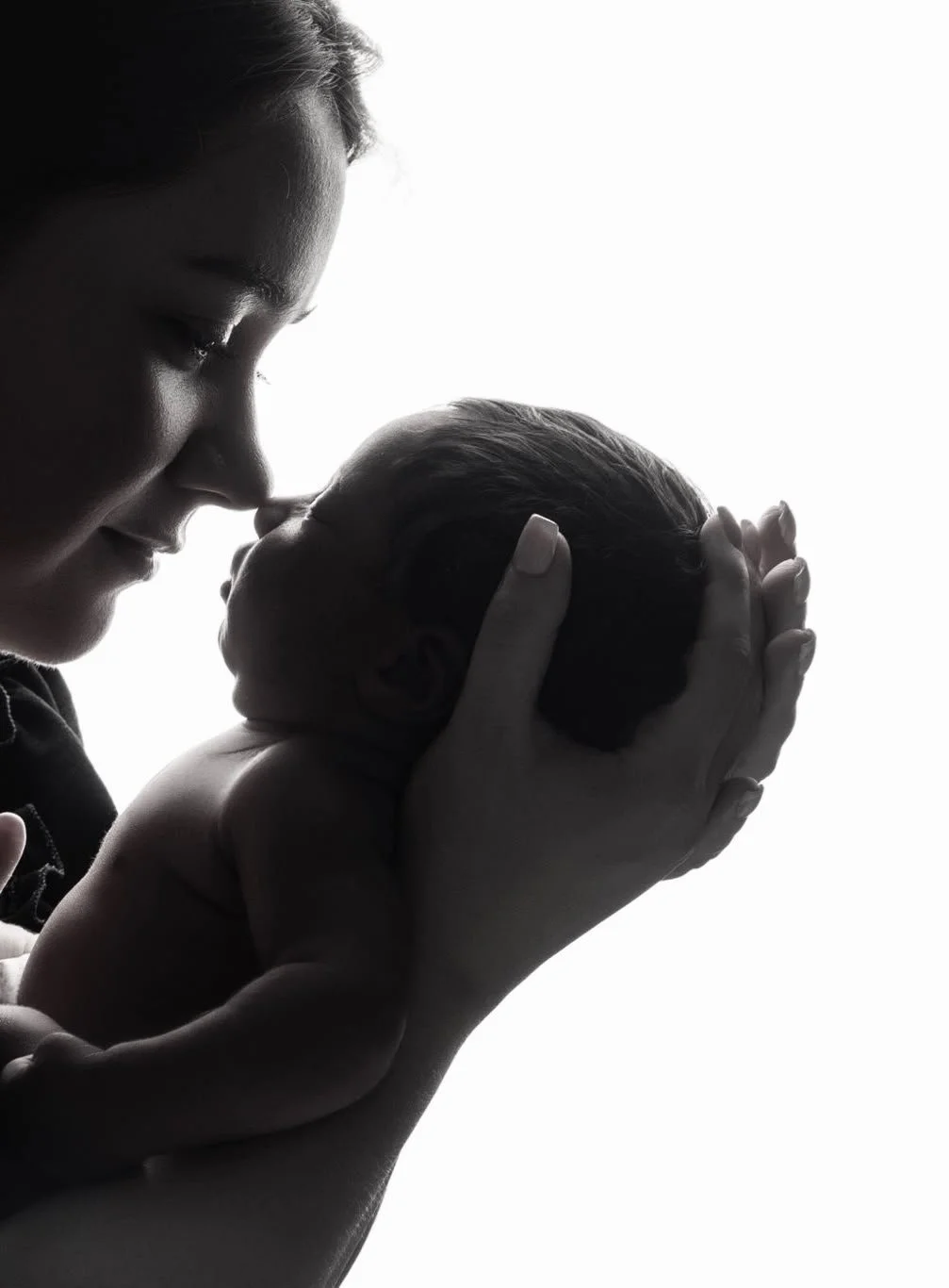 AM Skin House founder holding her baby