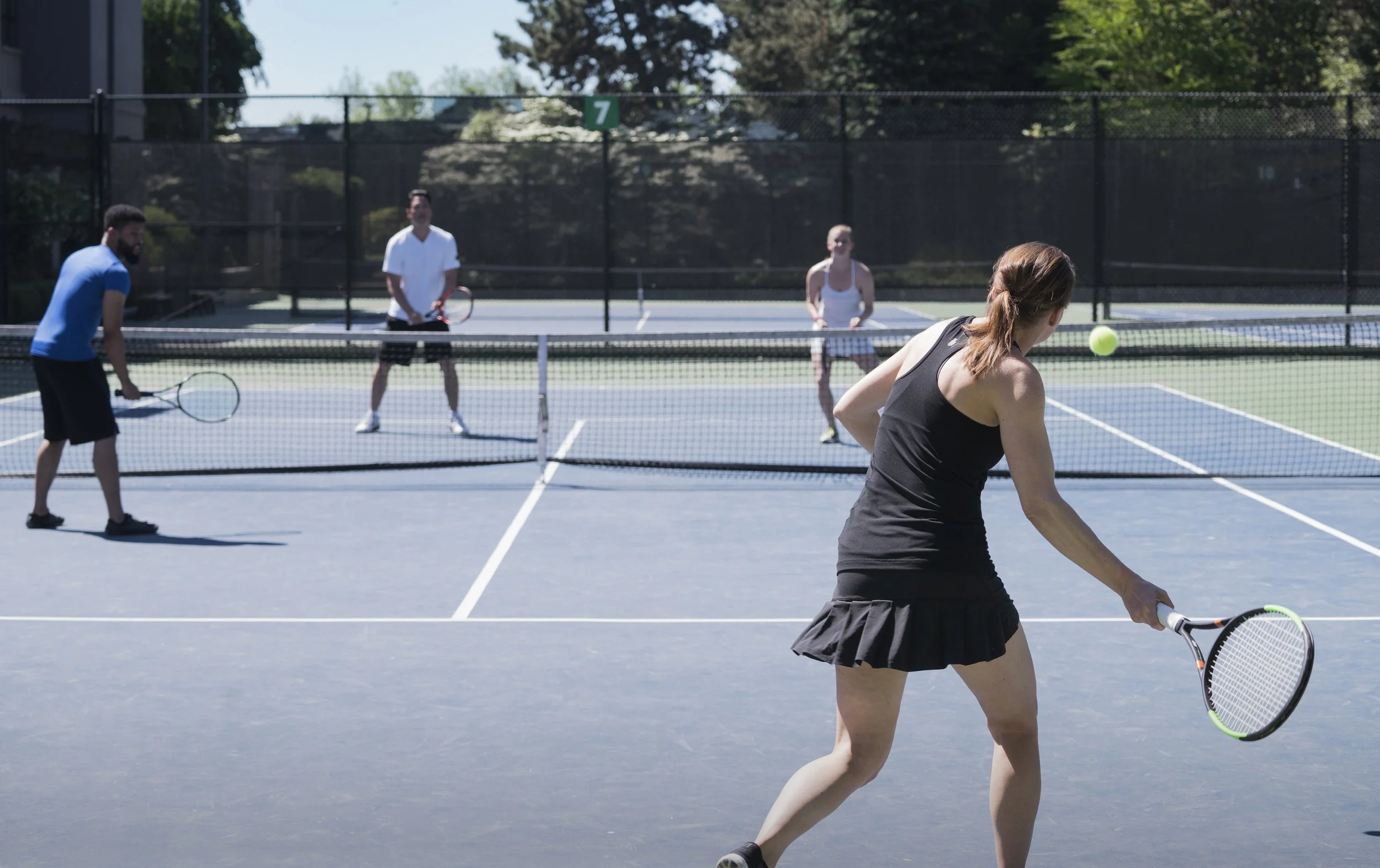 four-people-playing-tennis-on-a-sunny-day-2026-03-25-02-24-42-utc.jpg
