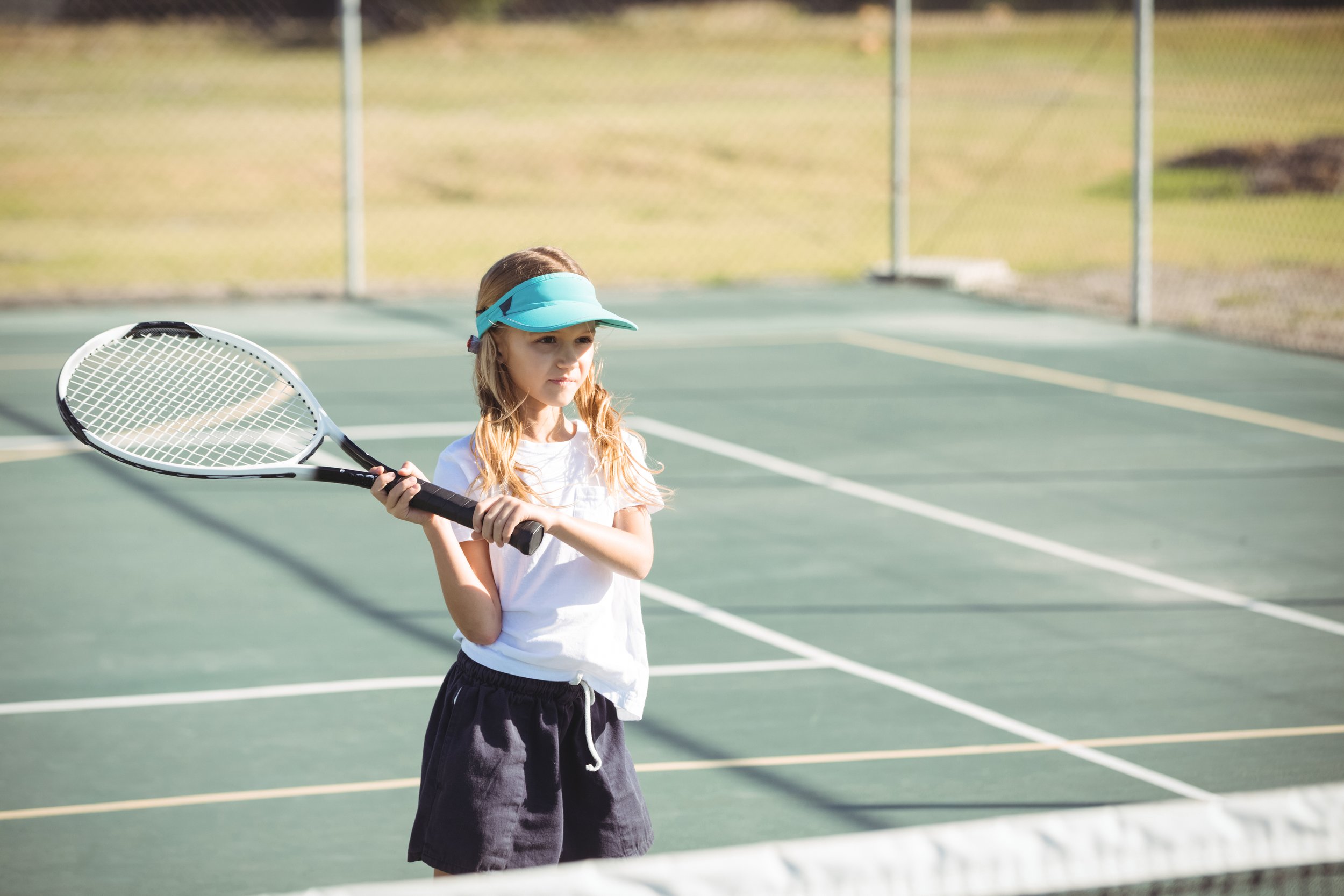 girl-plays-tennis-on-green-court-in-sunlight-2026-03-26-11-49-24-utc.jpg