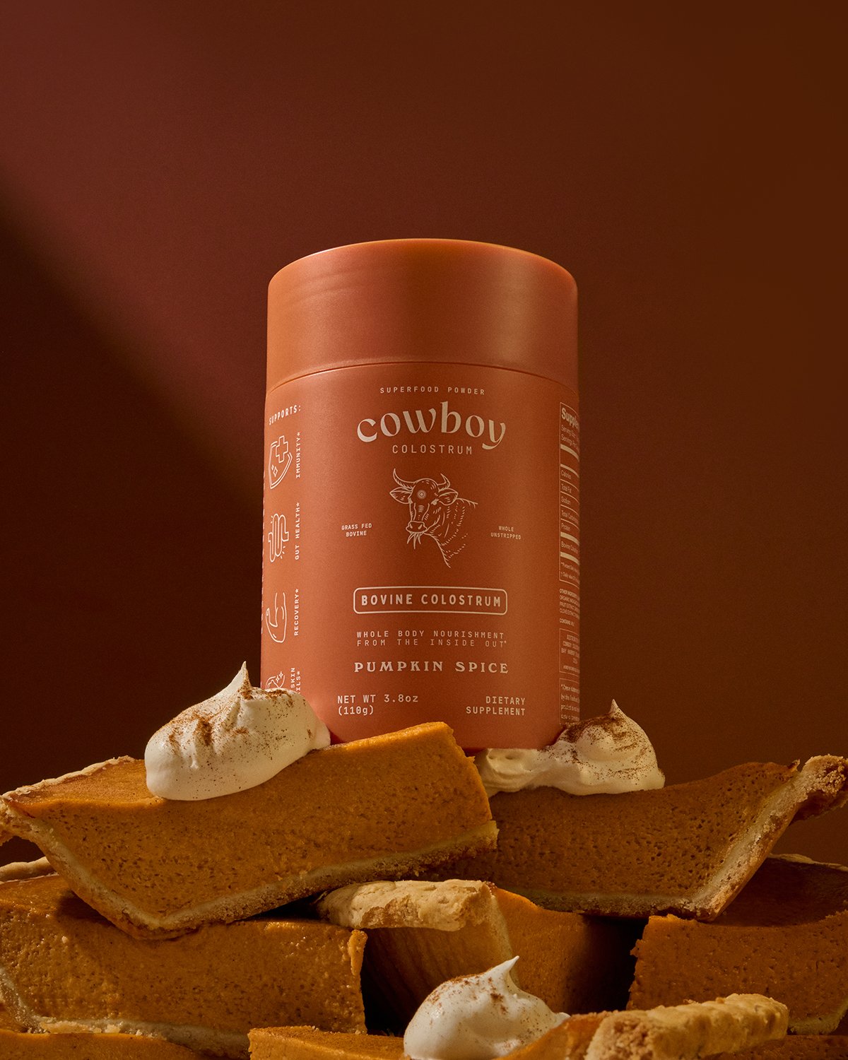 Cowboy-Colostrum_Pumpkin-Spice_Canister-on-Pumpkin-Pie-Slices_OPT.jpg