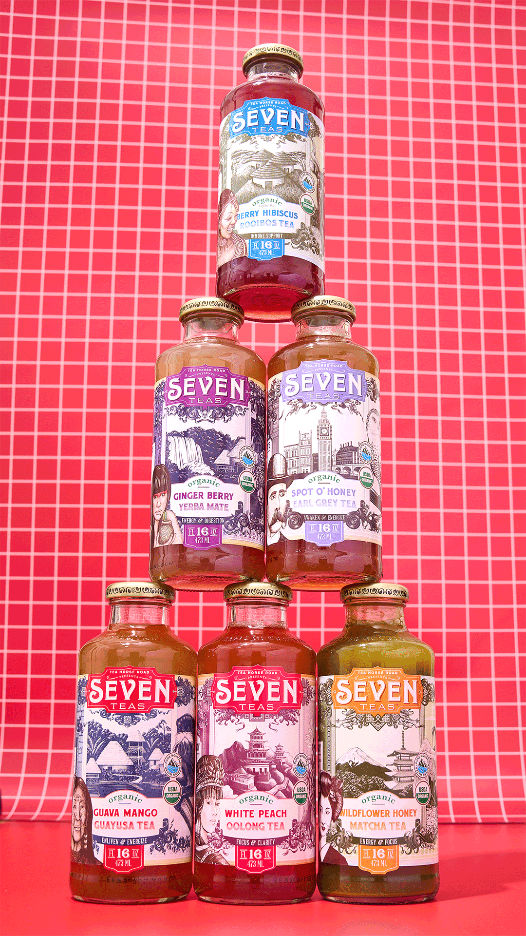 A pyramid of seven bottles of Seven Teas organic tea against a red grid background.