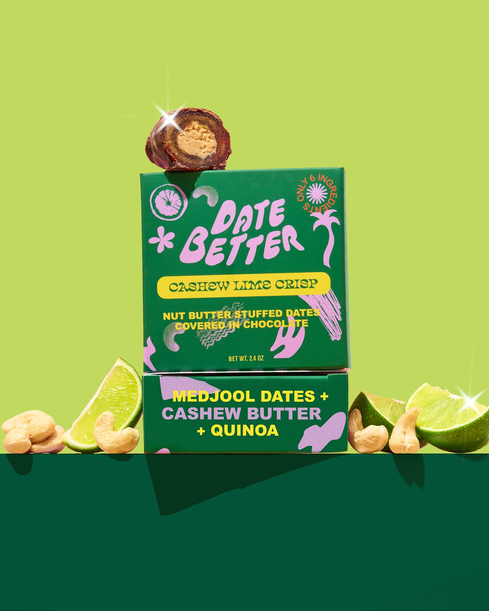 A box of Date Better cashew lime crisp with a chocolate-covered date snack on top, surrounded by lime slices, cashews, and dates against a green background.