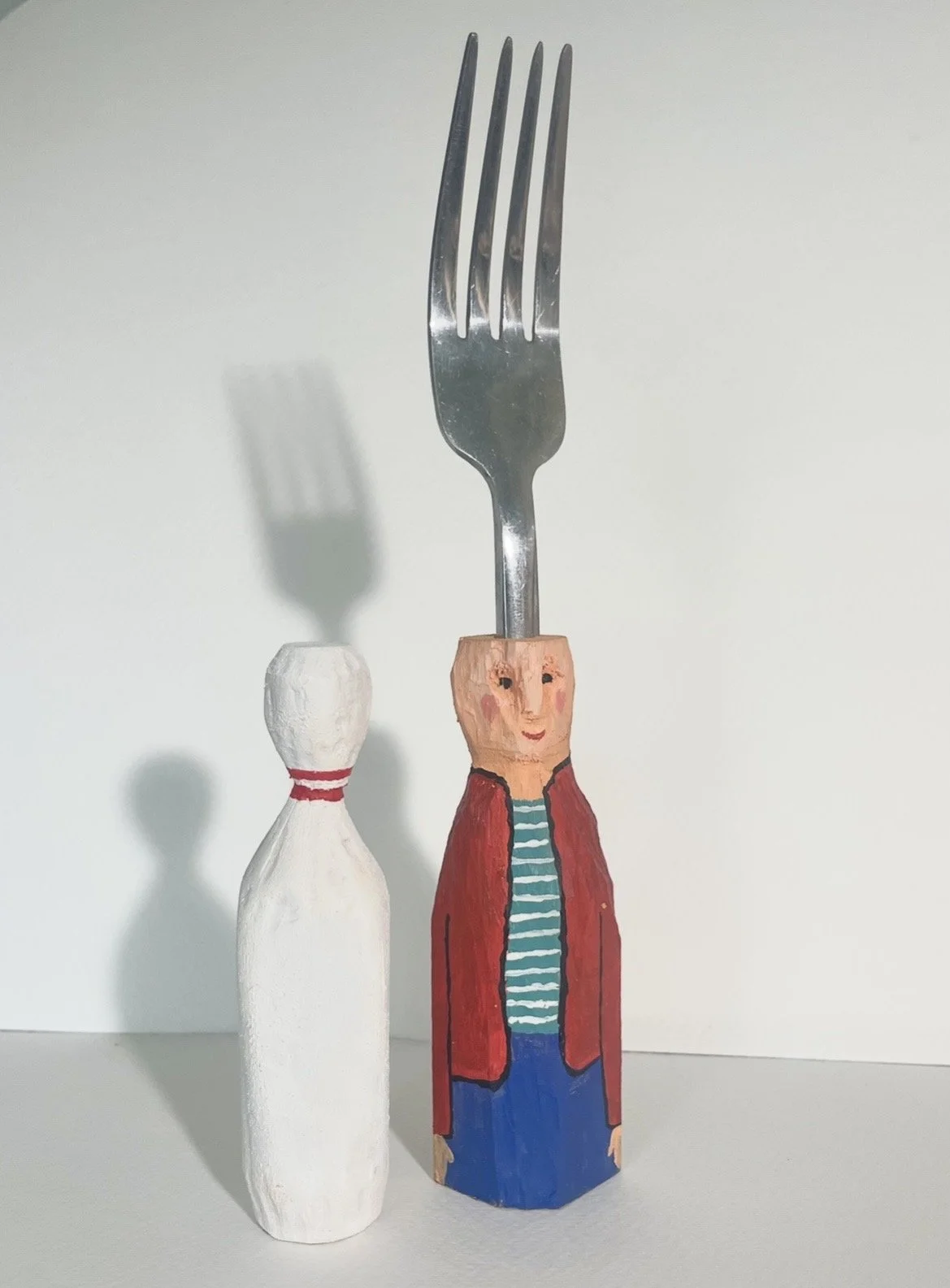 "A Fork and His Friend" wood carving and acrylic, 2026