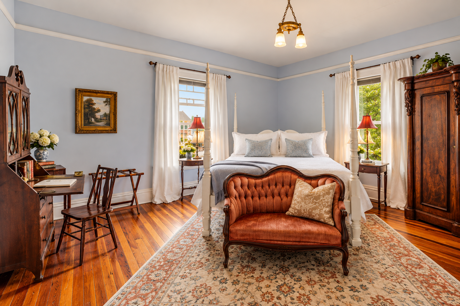 Room #4. The Margaret Mitchell Historic guest room at The Veranda Historic Inn in Senoia, GA, featuring a four-poster bed, hardwood floors and sitting area.