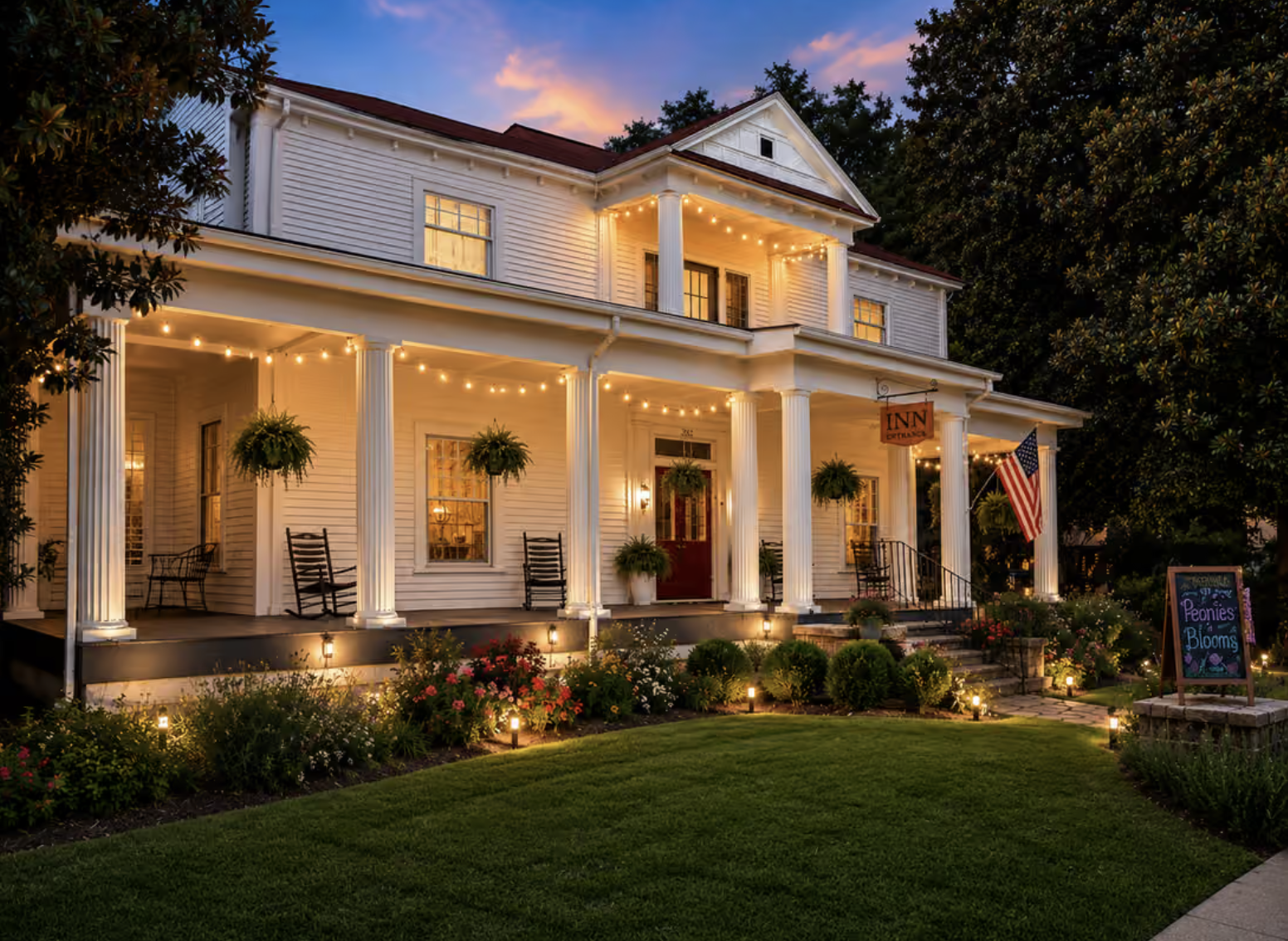 The Veranda Historic Inn in Senoia, Georgia, illuminated at dusk with its historic front porch and gardens.