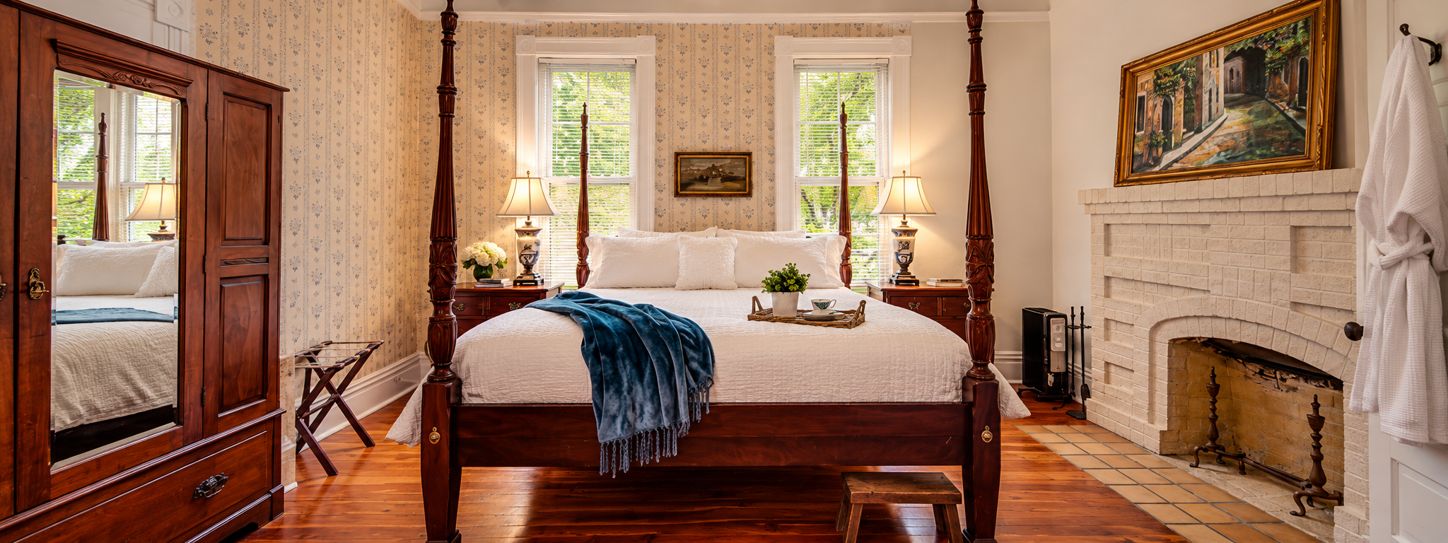 1906 Room, an Historic guest room at The Veranda Historic Inn in Senoia, GA, featuring a four-poster bed, fireplace and traditional furnishings.