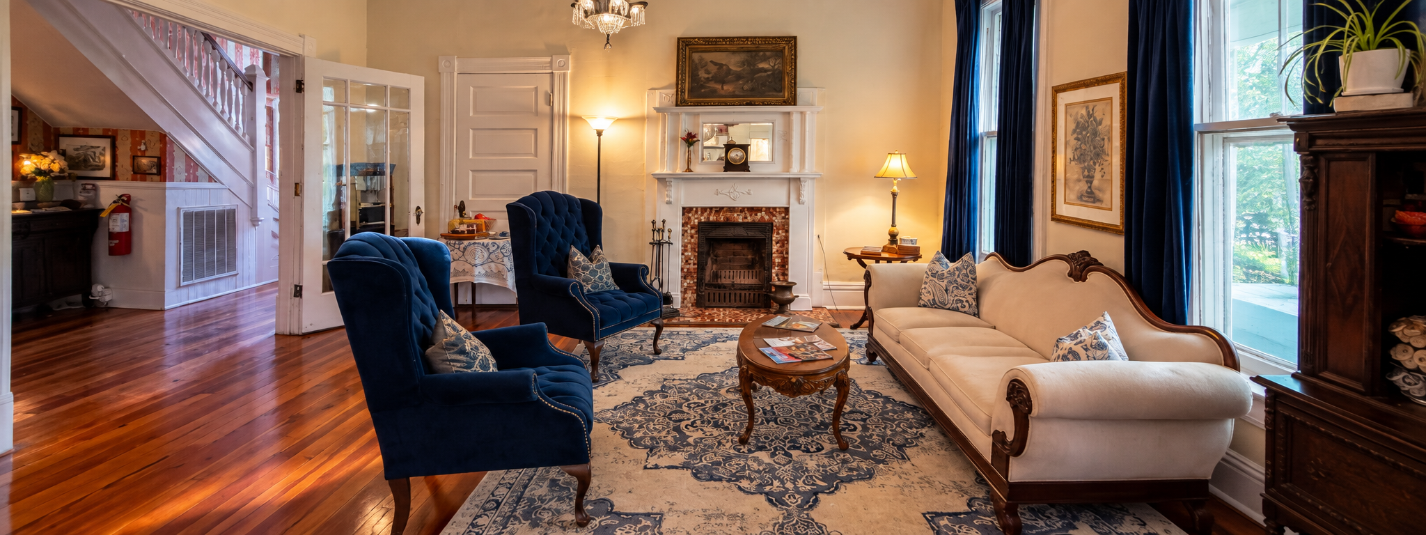 Historic parlor at The Veranda Historic Inn in Senoia, GA, featuring vintage furnishings, fireplace and original architectural character.