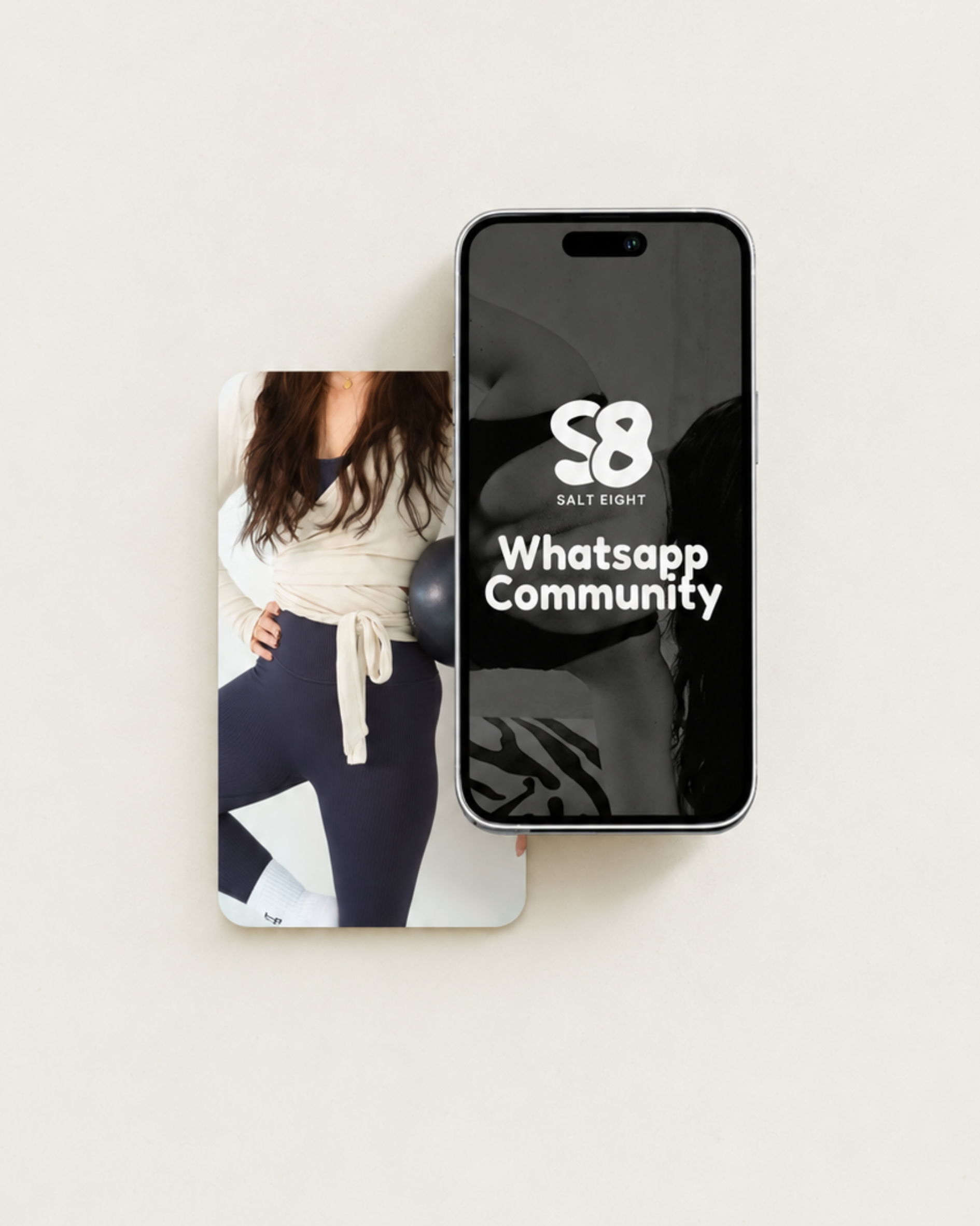 An iPhone displaying the WhatsApp Community logo, partially covering a printed image of a woman in athletic clothing.