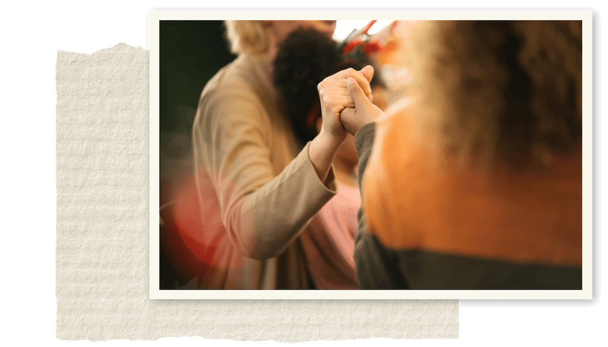 Two people holding hands during an arm-wrestling match, with only their hands and arms visible.